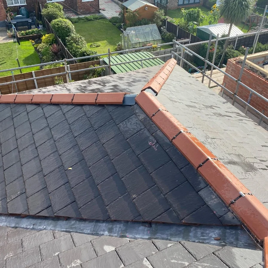 Slate roof with clay ridge tiles